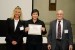 Prof. Suzanne Lunsford and Dr. Nagib Callaos giving Prof. Ariana Acon Matamoros an award certificate in appreciation for his presentation oriented to inter-disciplinary communication entitled: "Research Outcomes From Interdisciplinary Communication Between Computer Science and Academic Quality Management, at UNED."